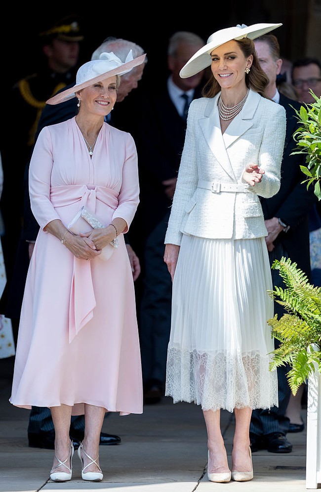Tampilan serba putih ini turut diperkuat dengan pilihan aksesori yang senada. Kate menenteng Strathberry Multress Chain Wallet, mengenakan pumps suede warna taupe, serta topi lebar karya Sean Barrett. (Foto: Getty Images)