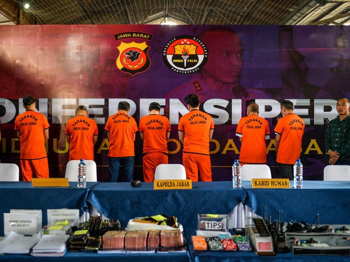 Barang bukti dan tersangka kasus judi kasino ditunjukkan kepada wartawan saat konferensi pers di Kosambi, Bandung, Jawa Barat, Rabu (18/6/2025). Polda Jabar mengungkap tempat judi kasino berkedok arena olahraga dan karaoke di Kota Bandung dan menangkap 44 tersangka beserta barang bukti berupa uang tunai Rp395 juta, kartu ATM dengan rekening berisi Rp2,7 milliar, dan meja kasino beserta perlengkapan judi. ANTARA FOTO/Raisan Al Farisi/nym.