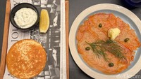 Untuk hidangan pembuka ada Saumon Fumé Maison, salmon asap rumahan yang disajikan dengan blinis, daun kucai, dan butter lokal. Aromanya smokey dan terasa segar. Foto: detikcom/Riska Fitria