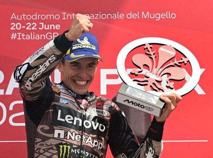 MotoGP - Italian Grand Prix - Mugello Circuit, Scarperia e San Piero, Italy - June 22, 2025 Ducati Lenovo Teams Marc Marquez celebrates on the podium with a trophy after winning the Italian Grand Prix REUTERS/Jennifer Lorenzini
