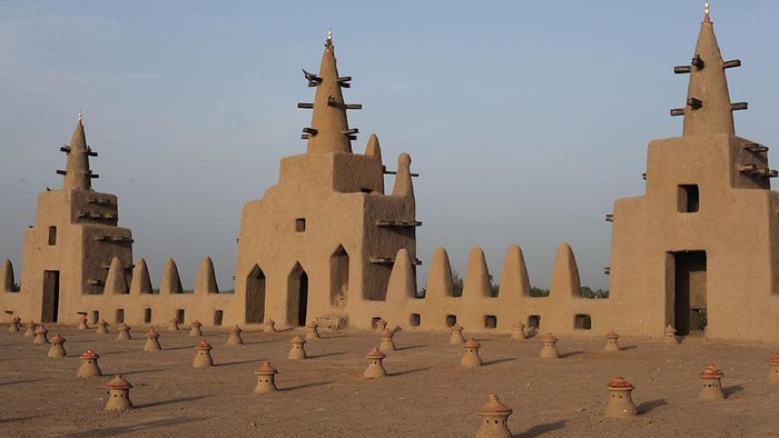 DJENNE, MALI - OCTOBER 6:  (FILE) - A view of the mud mosque and its minarets are seen in Djenne, Mali on October 6, 2014. The Great Mosque of Djenne is the largest mud brick building in the world and is considered by many architects to be one of the greatest achievements of the Sudano-Sahelian architectural style. As well as being the centre of the community of Djenne, it is one of the most famous landmarks in Africa and it was designated a World Heritage Site by UNESCO in 1988. (Photo by Muhammet Faruk Alagas/Anadolu Agency/Getty Images)
