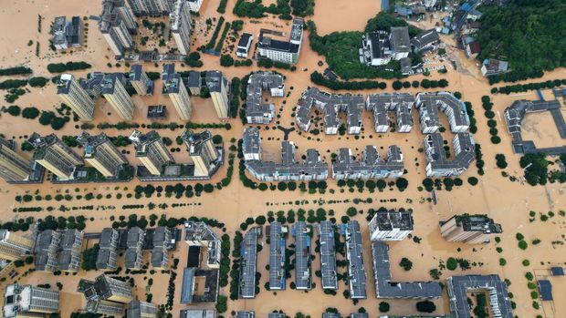 Pemandangan drone menunjukkan bangunan dan jalan setengah terendam banjir setelah hujan lebat, di daerah Rongjiang, provinsi Guizhoug, Tiongkok, 24 Juni 2025. China Daily via REUTERS