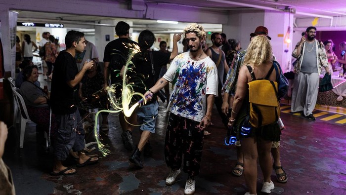 People dance in a headphones party inside a public shelter in an underground parking of a mall amid the Israel and Iran conflict in Tel Aviv, Israel June 23, 2025 REUTERS/Itai Ron ISRAEL OUT. NO COMMERCIAL OR EDITORIAL SALES IN ISRAEL      TPX IMAGES OF THE DAY