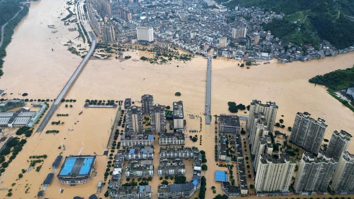 A drone view shows buildings and roads are half submerged in floodwaters after heavy rainfalls, in Rongjiang county, Guizhou province, China June 24. via China Daily Purchase Licensing Rights
