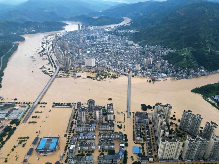 A drone view shows buildings and roads are half submerged in floodwaters after heavy rainfalls, in Rongjiang county, Guizhou province, China June 24. via China Daily Purchase Licensing Rights