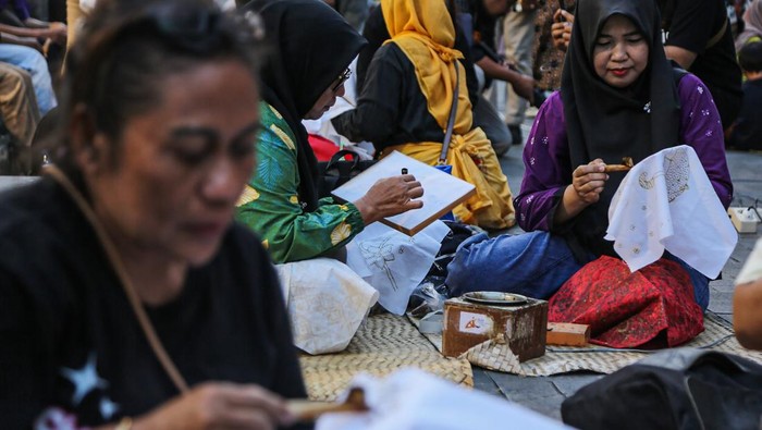 Sejumlah peserta mempraktikkan cara membuat motif batik menggunakan canting tradisional saat mengikuti Gerakan Belajar Membatik di kawasan Cagar Budaya Nasional Kota Lama, Semarang, Jawa Tengah, Jumat (27/6/2025). Kegiatan belajar membatik gratis di ruang publik yang diikuti puluhan peserta lintas generasi bertajuk Kresem Art Street #4 tersebut dalam rangka memperingati 19 tahun revitalisasi batik Semarang sekaligus sebagai upaya melestarikan dan menumbuhkan rasa cinta pada salah satu kain wastra khas Indonesia. ANTARA FOTO/Makna Zaezar/rwa.