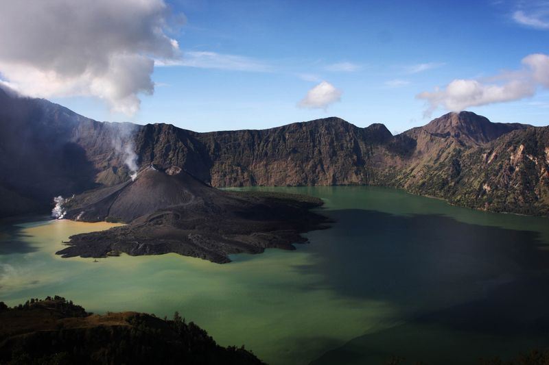 SENARU, LOMBOK, INDONESIA - MAY 19: A view of Mount Rinjani, also known as Gunung Rinjani, is seen on May 19, 2009 in Lombok, West Nusa Tenggara Province, Indonesia. The 3,726m active volcano is the third highest in Indonesia, and has been erupting this time around April 27, peaking on May 10. The volcano's crater lake, known as Segara Anak, is home to many goldfish and mujair fish and is a popular fishing spot for locals.  (Photo by Ulet Ifansasti/Getty Images)