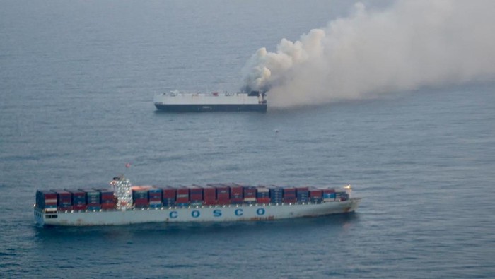 Smoke rises from a fire aboard the cargo vessel Morning Midas, carrying around 3,000 vehicles, including 800 electric vehicles, as seen in an aerial photograph taken from a U.S. Coast Guard C-130J Super Hercules, approximately 300 miles south of Adak, Alaska, U.S. June 3, 2025.  U.S. Coast Guard/Air Station Kodiak/Handout via REUTERS.  THIS IMAGE HAS BEEN SUPPLIED BY A THIRD PARTY