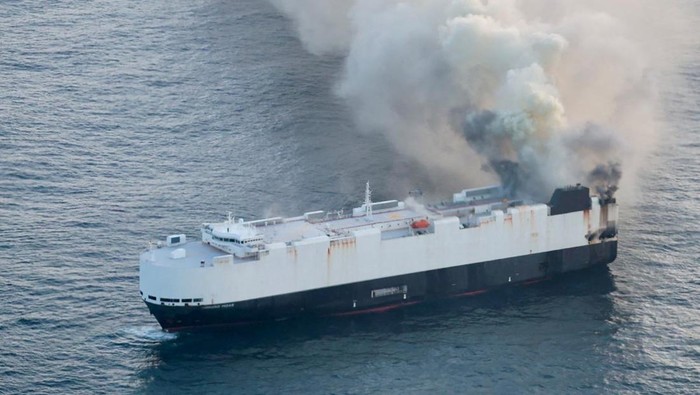 Smoke rises from a fire aboard the cargo vessel Morning Midas, carrying around 3,000 vehicles, including 800 electric vehicles, as seen in an aerial photograph taken from a U.S. Coast Guard C-130J Super Hercules, approximately 300 miles south of Adak, Alaska, U.S. June 3, 2025.  U.S. Coast Guard/Air Station Kodiak/Handout via REUTERS.  THIS IMAGE HAS BEEN SUPPLIED BY A THIRD PARTY