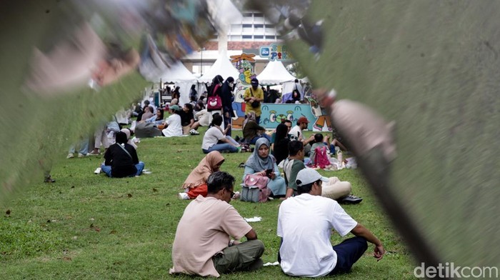 Lapangan Banteng, Jakarta, dipadati pengunjung saat momen libur panjang. Pengunjung mengisi liburan dengan piknik hingga berbelanja.