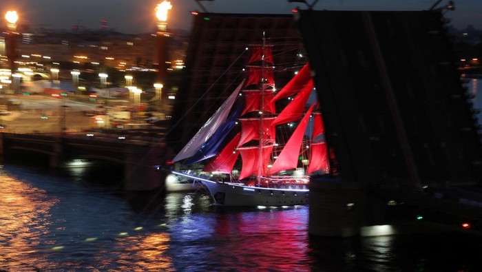 Spectators watch fireworks exploding in the sky and the brig 