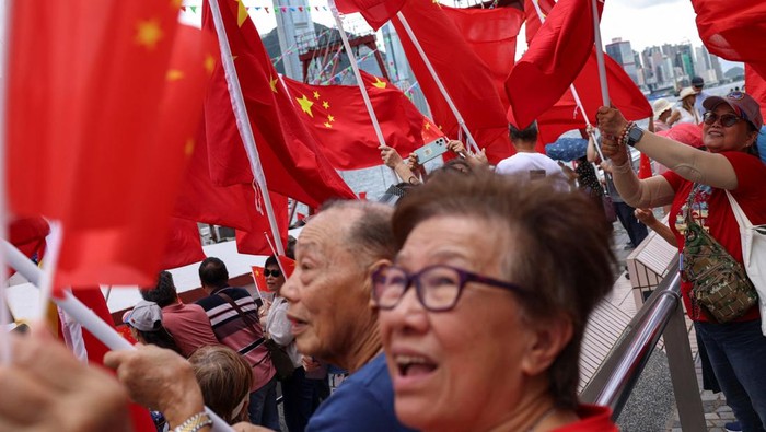 Suasana peringatan 28 tahun penyerahan Hong Kong dari Inggris ke pemerintahan Tiongkok berlangsung meriah pada Senin (1/7/2025). Sejumlah pendukung pro-Tiongkok terlihat mengibarkan bendera nasional Tiongkok dan bendera Hong Kong dalam berbagai rangkaian acara di wilayah tersebut. REUTERS/Tyrone Siu