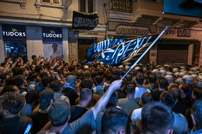 Islamist protesters clash with Turkish anti riot police officers as they gather to protests Leman cartoon magazine in Istanbul on June 30,2025. Clashes erupted in Istanbul Monday with police firing rubber bullets and tear gas to break up an angry mob after allegations that a satirical magazine had published a cartoon of the Prophet Mohammed, an AFP correspondent said. The incident occurred after Istanbul's chief prosecutor ordered the arrest of the editors at LeMan magazine on grounds it had published a cartoon which 