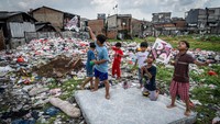 Anak-anak bermain di dekat tumpukan sampah. Sampah tersebut menumpuk akibat minimnya kesadaran warga dalam menjaga kebersihan dan kelestarian lingkungan. Foto: ANTARA FOTO/Bayu Pratama S 