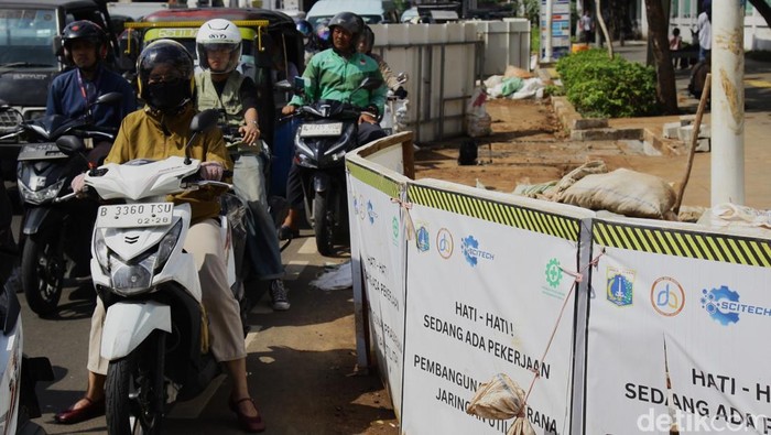 Tata Kabel Bawah Tanah, Proyek Galian SJUT Warnai Jalan Matraman Pengendara melintas di samping proyek galian kabel di Jalan Matraman Raya, Jakarta Timur, Rabu (2/6/2025). Pemerintah Jakarta gencar menggarap proyek Sarana Jaringan Utilitas Terpadu (SJUT) dengan menata jaringan utilitas atau kabel udara ke bawah tanah.