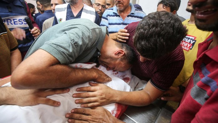 Palestinians react over bodies as they mourn doctor Marwan al-Sultan, director of the Indonesian Hospital in northern Gaza Strip, his wife, his daughter and and his sister, who were killed in an Israeli strike on Wednesday, according to Gaza’s health ministry, at Al-Shifa hospital in Gaza City, July 2, 2025. REUTERS/Mahmoud Issa