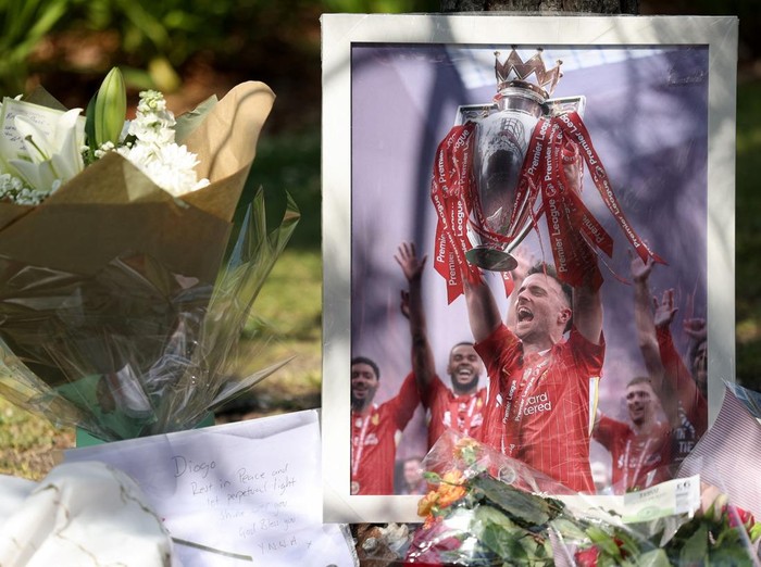 A picture of Liverpool's Portuguese soccer player Diogo Jota stands next to flower tributes, after Jota died in a car crash near Zamora, Spain, outside Anfield Stadium in Liverpool, Britain, July 3, 2025. REUTERS/Temilade Adelaja