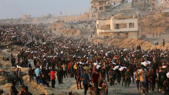 Palestinians gather to receive aid supplies in Beit Lahia, in the northern Gaza Strip, on June 17, 2025. (Reuters)