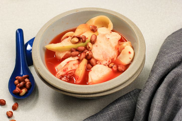 Asinan Buah Bogor (Rujak Buah), Fruit Pickle Made from Sliced Fresh Tropical Fruits On Sweet, Sour and Spicy Red Soup. Topped with Fried Peanuts Famous during Ramadhan.