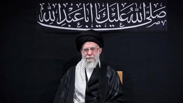 This handout picture released by the office of Irans Supreme Leader Ayatollah Ali Khamenei on July 5, 2025 shows him (R) waving to the audience during a mourning ceremony in Tehran marking the ninth day of the Islamic month of Muharram in the lead-up to Ashura, a 10-day period commemorating the seventh century killing of Prophet Mohammeds grandson Imam Hussein. Irans supreme leader on July 5 made his first public appearance since the outbreak of his countrys recent 12-day war with Israel, state media reported, greeting worshippers and being cheered at a mosque in a video broadcast by state television. (Photo by LEADER OFFICE / AFP) / === RESTRICTED TO EDITORIAL USE - MANDATORY CREDIT 