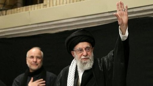 This handout picture released by the office of Irans Supreme Leader Ayatollah Ali Khamenei on July 5, 2025 shows him (R) waving to the audience during a mourning ceremony in Tehran marking the ninth day of the Islamic month of Muharram in the lead-up to Ashura, a 10-day period commemorating the seventh century killing of Prophet Mohammeds grandson Imam Hussein. Irans supreme leader on July 5 made his first public appearance since the outbreak of his countrys recent 12-day war with Israel, state media reported, greeting worshippers and being cheered at a mosque in a video broadcast by state television. (Photo by LEADER OFFICE / AFP) / === RESTRICTED TO EDITORIAL USE - MANDATORY CREDIT AFP PHOTO / HO / KHAMENEI.IR - NO MARKETING NO ADVERTISING CAMPAIGNS - DISTRIBUTED AS A SERVICE TO CLIENTS ===