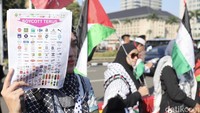 Para peserta membawa spanduk bertuliskan From Women to Gaza, You Are Not Alone.