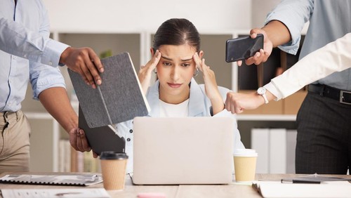Stress, anxiety and multitasking business woman with headache from workload and laptop deadline in office. Burnout, frustration and overwhelmed lady exhausted, procrastination in toxic workplace