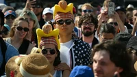 Untuk memeriahkan acara, tak sedikit pengunjung yang pakai topi hot dog. Tampilannya lucu dan unik ya? Foto: Angela Weiss, AFP Via Getty Images via USA Today