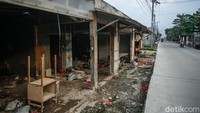 Seorang pria mengangkut barang-barangnya dari rumah kontrakan yang berdiri di atas lahan irigasi yang akan ditertibkan.