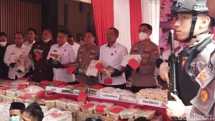 2. Belasan tersangka narkotika terborgol-berjalan dengan pengawalan petugas kepolisian bersenjata menuju Ditresnarkoba Polda Jatim