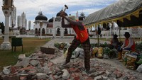 Pekerja membongkar lantai keramik halaman masjid yang rusak. Pemprov Aceh mengalokasikan anggaran tahun 2024 dan 2025 sebesar Rp50 miliar untuk renovasi Masjid Raya Baiturrahman. Foto: ANTARA FOTO/Ampelsa