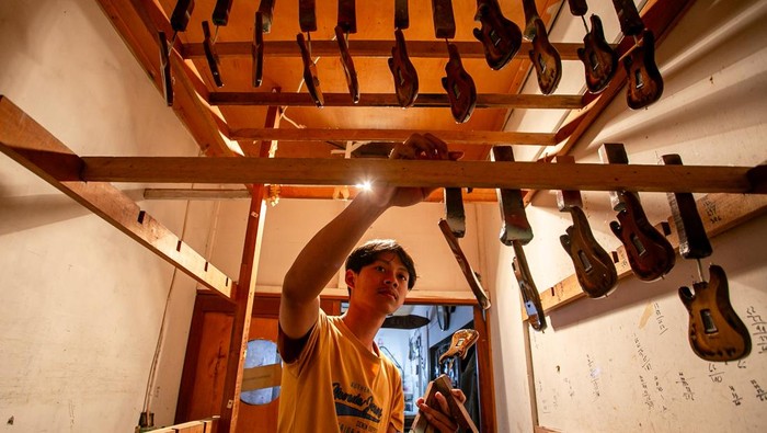 Keren, Miniatur Gitar Asal Klaten Tembus Pasar Amerika Pekerja menyelesaikan pembuatan kerajinan miniatur gitar di desa Manjungan, Ngawen, Klaten, Jawa Tengah, Kamis (10/7/2025). Miniatur gitar berbahan utama kayu mahoni tersebut telah menembus pasar internasional hingga ekspor ke Amerika Serikat untuk barang suvenir dan koleksi khususnya untuk miniatur gitar replika milik musisi legendaris seperti Slash dari Guns N' Roses, Paul Mc Carthney The Beatles, Bob Marley, George Harrison, dan Pink Floyd. ANTARA FOTO/Mohammad Ayudha