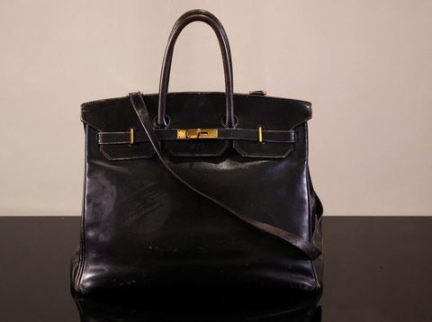 A cameraman films the Original Birkin, the handbag crafted by French luxury fashion house Hermes for artist Jane Birkin and offered to her in 1985, displayed during a media preview of Sotheby's Paris Fashion Icons Sale at Sotheby's auction house in Paris, France, July 2, 2025. REUTERS/Tom Nicholson