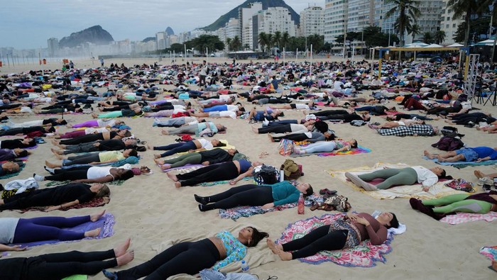 People attend a massive yoga class, of the 