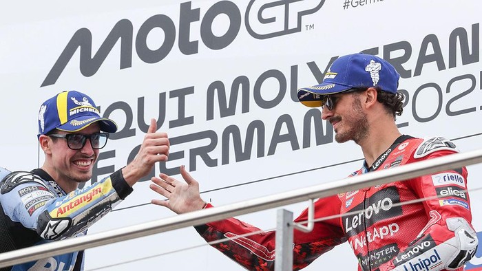 HOHENSTEIN-ERNSTTHAL, GERMANY - JULY 13: Francesco Bagnaia of Italy riding the Lenovo Ducati (63) and Alex Marquez of Spain riding the BK8 Gresini Racing Ducati (73) on the podium during the the MotoGP of Germany race at Sachsenring Circuit on July 13, 2025 in Hohenstein-Ernstthal, Germany. (Photo by Gold & Goose Photography/Getty Images)