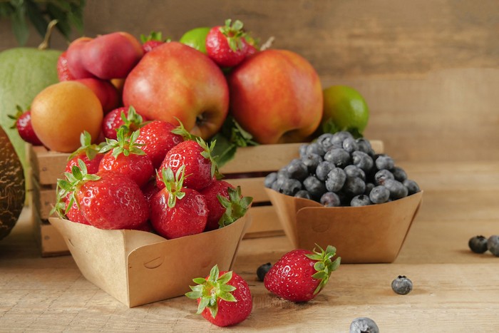 Ilustrasi buah-buahan Fresh fruits. Healthy food. Mixed fruit, apricots and peaches. Blueberry. various fruits on an old wooden table. Organic healthy assorted fruits. place for text