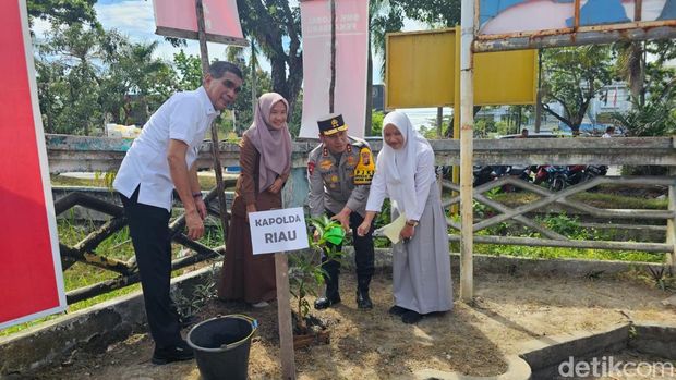 Kapolda Riau Irjen Herry Heryawan melakukan penanaman pohon di SMK Global, Kota Pekanbaru, Senin (14/7/2025).