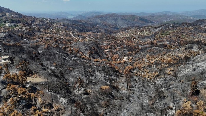 Kebakaran Hanguskan Ribuan Hektar Lahan di Pedesaan Latakia Suriah A drone view shows scorched hillsides and damaged buildings, following massive wildfires, in Latakia countryside, Syria, July 13, 2025. REUTERS/Karam al-Masri TPX IMAGES OF THE DAY