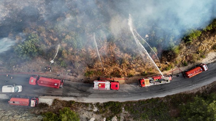 A drone view shows scorched hillsides and damaged buildings, following massive wildfires, in Latakia countryside, Syria, July 13, 2025. REUTERS/Karam al-Masri       TPX IMAGES OF THE DAY