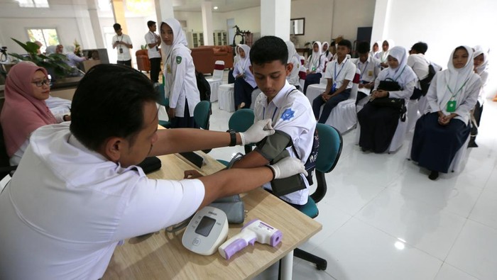 Petugas memeriksa kesehatan siswa sekolah rakyat Sentra Darussa'adah di Aceh Besar, Aceh, Minggu (13/7/2025). Sebanyak 100 siswa program sekolah rakyat  Sentra Darussa'adah mulai mengikuti menjalani pemeriksaan kesehatan dan mengikuti masa pengenalan lingkungan sekolah pada hari pertama mengikuti pendidikan tahun ajaran baru 2025/2026. ANTARA FOTO/Irwansyah Putra/rwa.
