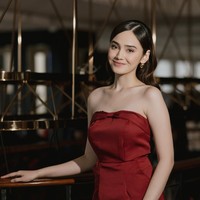 Syifa tampil cantik kenakan tube dress simpel berwarna merah. Rambutnya tampak dibiarkan terurai dengan model sleek di bagian depan dan mermaid curl. Foto: Instagram/@syifahadju