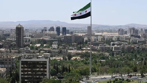 A large Syrian flag flutters above Tishreen Park in Damascus on June 4, 2025. (AFP)