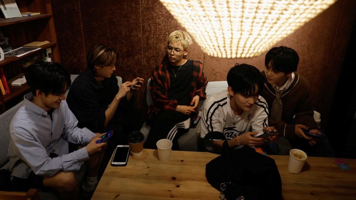 Members of K-pop boy band 1VERSE, including Hyuk and Seok, who defected from North Korea, as well as Aito, Nathan and Kenny, get some rest before they record their new track at a studio in Seoul, South Korea, June 26, 2025. REUTERS/Kim Soo-hyeon