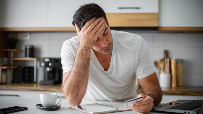 Man having financial problems with credit card debt mortgage