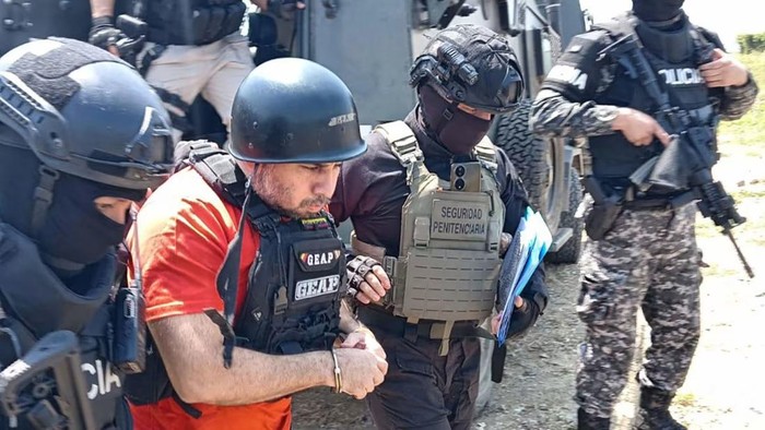 Ecuadors prison authorities provided this photo showing Jose Adolfo Macias, better known as “Fito,” being escorted by police officers in Guayaquil, Ecuador, as he was extradited to the US on Sunday, July 20, 2025. (Ecuador Prison Authorities)