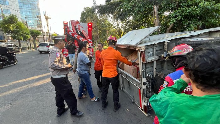 Penampakan pikap terguling di Jalan Jemursari Surabaya