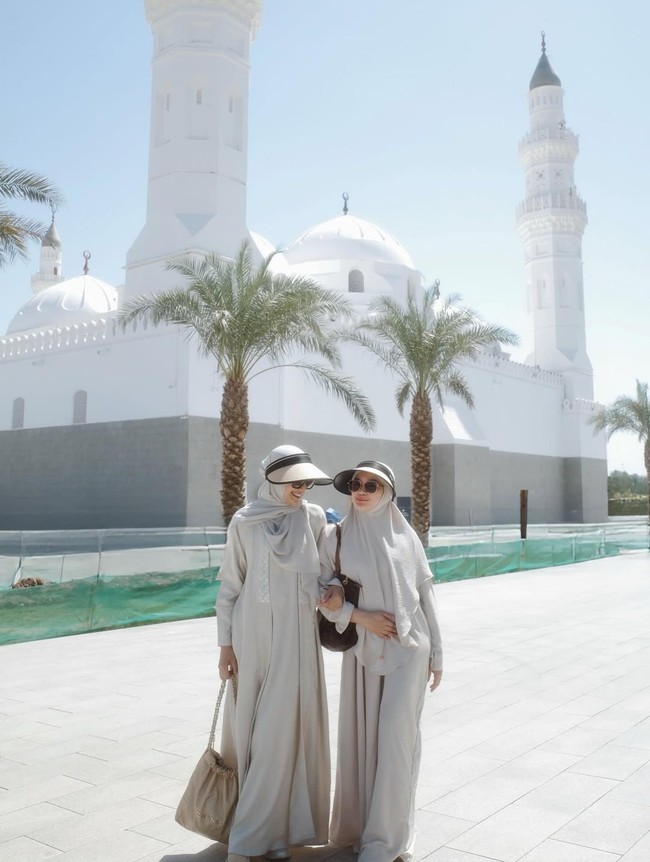Saat berada di Masjid Quba, Annisa Aziza tampil elegan dengan hijab segi empat abu-abu dan dress warna senada. Umrah tak ditemani suaminya Raditya Dika, Annisa berpose bersama Rizki Amelia. Foto: Dok. Instagram @anissaaziza