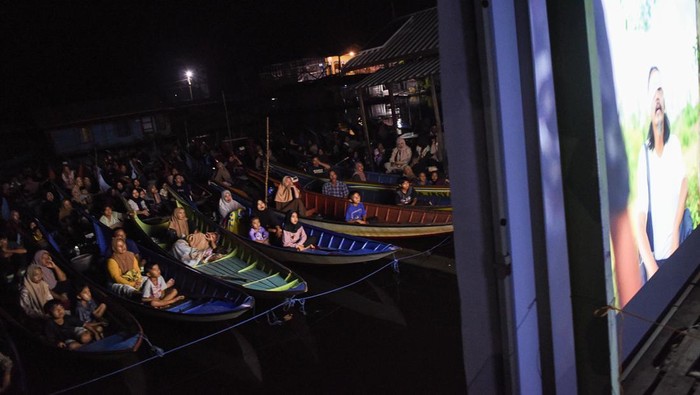 Foto udara sejumlah warga menonton bioskop terapung dari perahunya di Desa Muara Enggelam, Muara Wis, Kutai Kartanegara, Kalimantan Timur, Selasa (22/7/2025). Bioskop terapung yang diinisiasi oleh Layar Mahakama berlangsung di tiga danau di Kalimantan Timur yakni Danau Semayang di Desa Sangkuliman, Danau Melintang di Desa Muara Enggelam, dan Danau Jempang di Desa Tanjung Jone itu hadir sebagai alternatif hiburan untuk masyarakat pesisir yang selama ini jauh dari akses bioskop konvensional. ANTARA FOTO/M Risyal Hidayat/tom.
