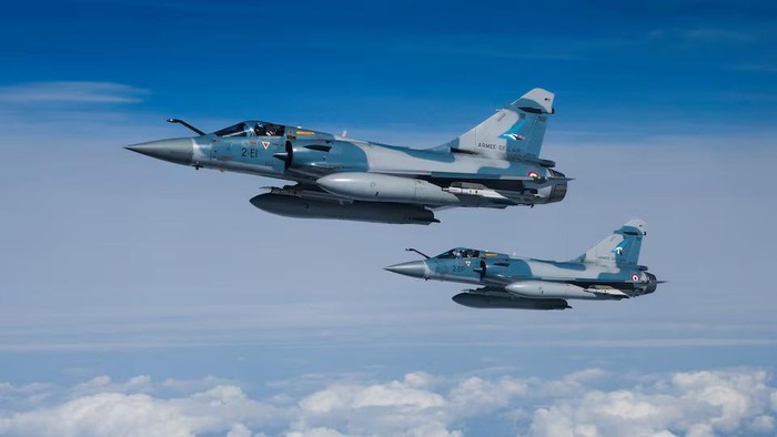 Two Mirage 2000-5F fighter jets of the French Air Force are seen next to an Airbus A330 MRTT 