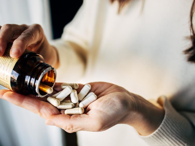 Woman taking vitamin pills
